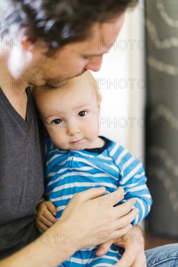 Father embracing son (12-17 months)