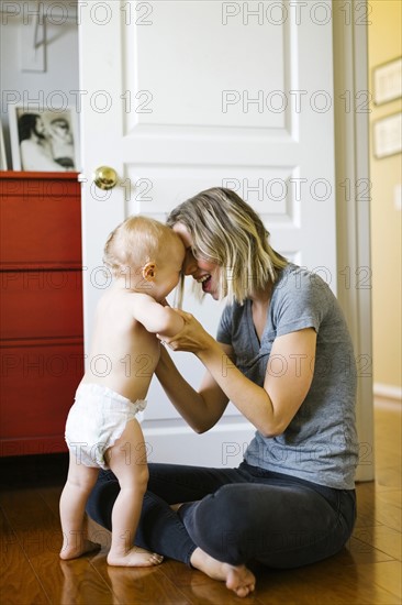 Mother holding son (12-17 months)