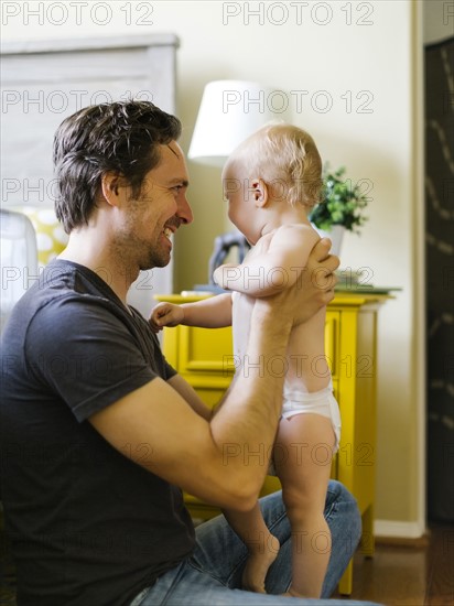 Father holding son (12-17 months)
