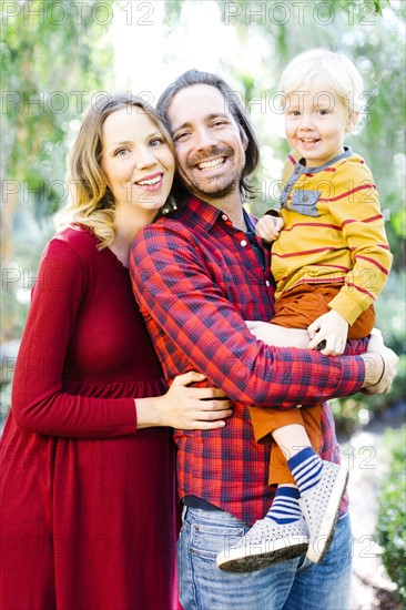 Portrait of parents with son (4-5) in park