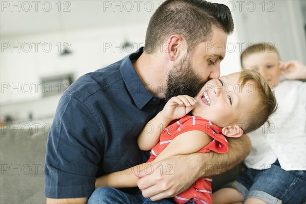 Father kissing son (2-3) on cheek