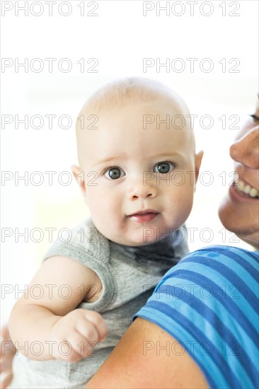 Mother holding son (6-11 months)