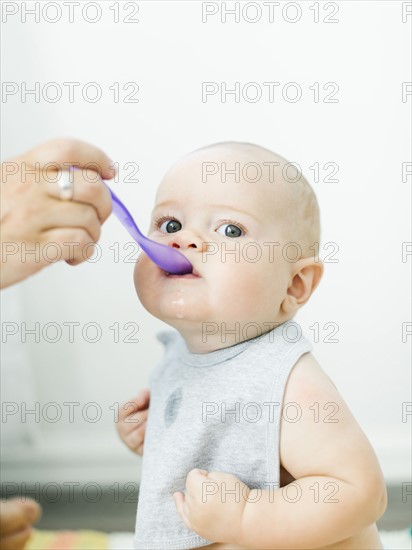 Mother feeding son (6-11 months)