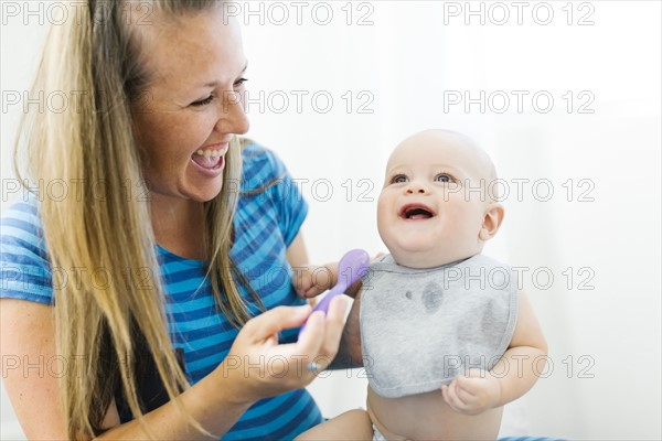 Mother feeding son (6-11 months)