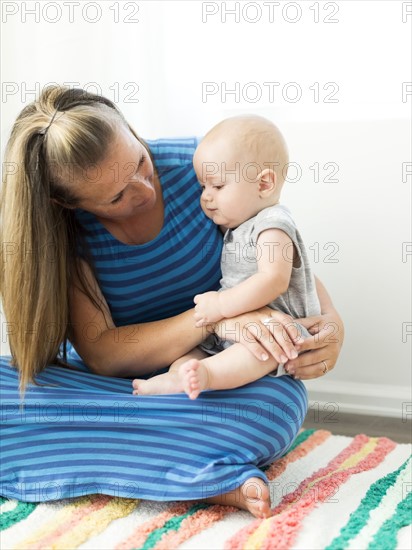 Mother holding her son (6-11 months) on lap