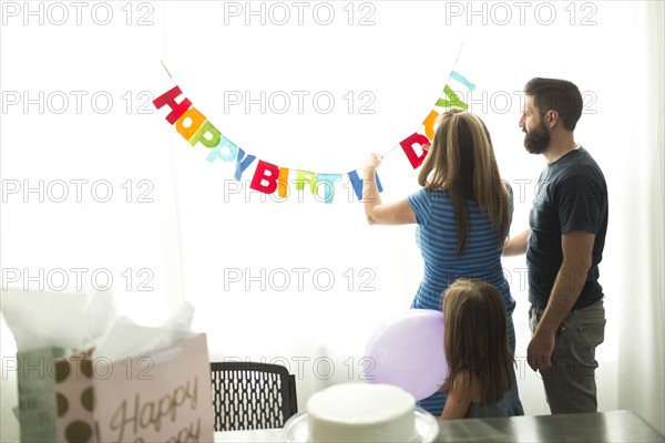 Family with one child (6-7) preparing birthday party