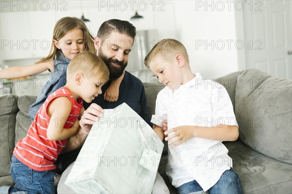 Family with three children (2-3, 6-7) celebrating fathers day