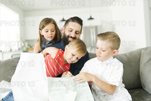 Family with three children (2-3, 6-7) celebrating fathers day