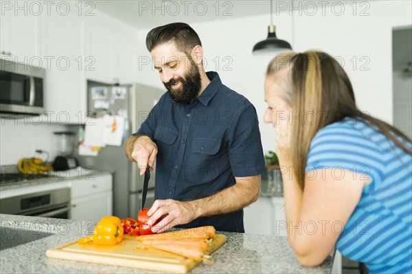 Mid adult couple cooking together