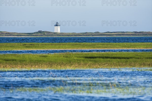 USA, Massachusetts, Cape Cod, Provincetown, Bay of water with lighthouse