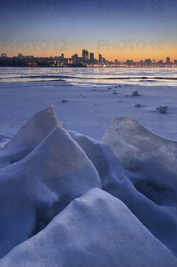 Ukraine, Dnepropetrovsk region, Dnepropetrovsk city, Frozen river with distant city skyline