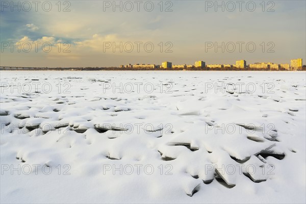 Ukraine, Dnepropetrovsk region, Dnepropetrovsk city, Frozen river with distant cityscape