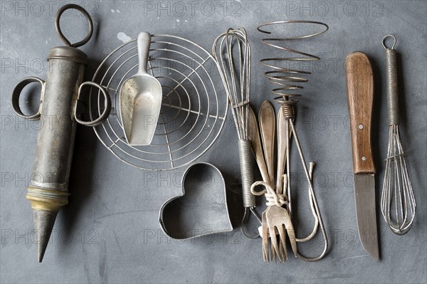 Group of vintage cooking utensils on gray background