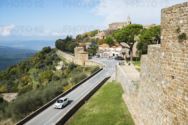 Italy, Tuscany, Montalcino, View of ancient Montalcino city and fortress walls on hill