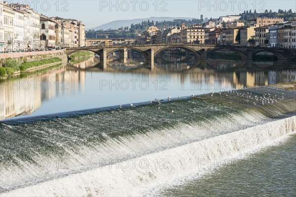 Italy, Tuscany, Florence, Cityscape reflected in Arno river