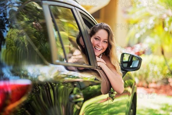 Portrait of woman looking out of car window