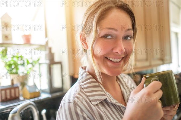 Portrait of smiling woman with mug