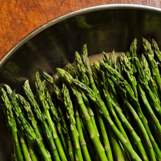 Green asparagus in metal pot