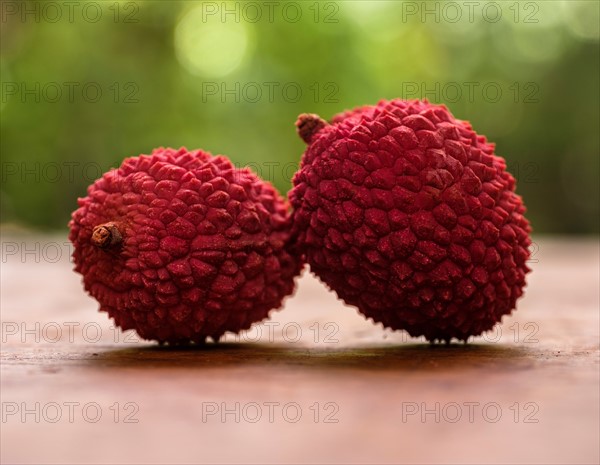 Two lychee on table