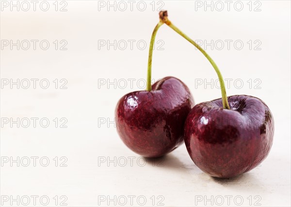 Shiny cherries on white background