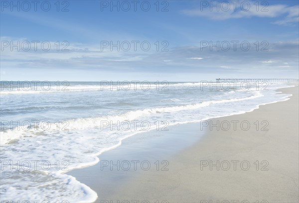 Waves splashing into sandy beach