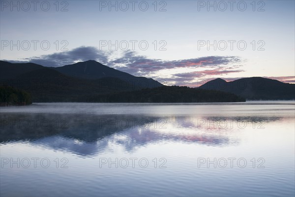 USA, New York, Silhouette of mountains with Lake Placid in foreground at sunrise