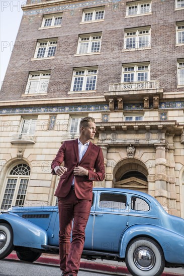 USA, Utah, Salt Lake city, Elegant man crossing street, vintage car in background