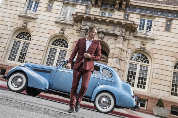 USA, Utah, Salt Lake city, Elegant man crossing street, vintage car in background