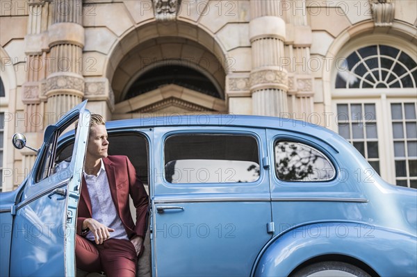 Elegant man sitting in vintage car