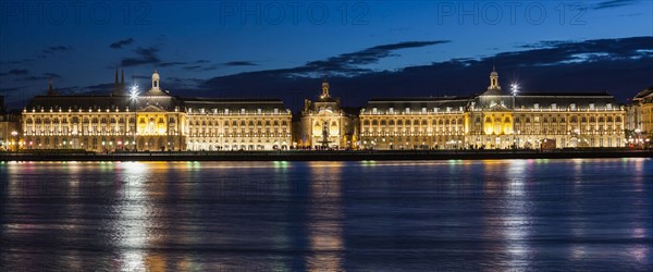 France, Nouvelle-Aquitaine, Bordeaux, Place de la Bourse across Garonne River at night