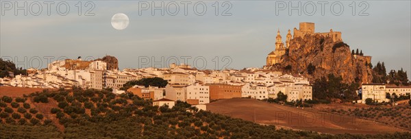 Spain, Andalusia, Olvera, Panoramic view of townscape with moonrise