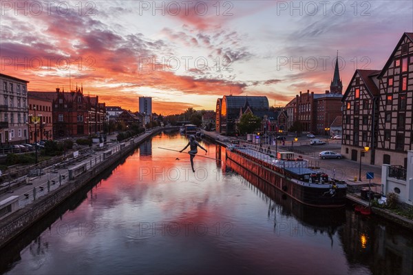 Poland, Kuyavian-Pomeranian, Bydgoszcz, Brda River, Dramatic sky reflecting in water surface