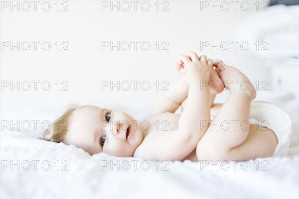 Portrait of baby girl (6-11 Months) looking at camera and smiling