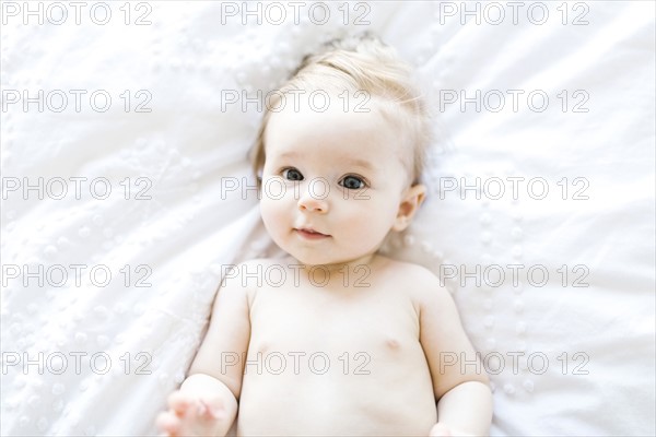 Portrait of baby girl (6-11 Months) smiling, directly above