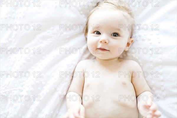 Portrait of baby girl (6-11 Months) smiling, directly above