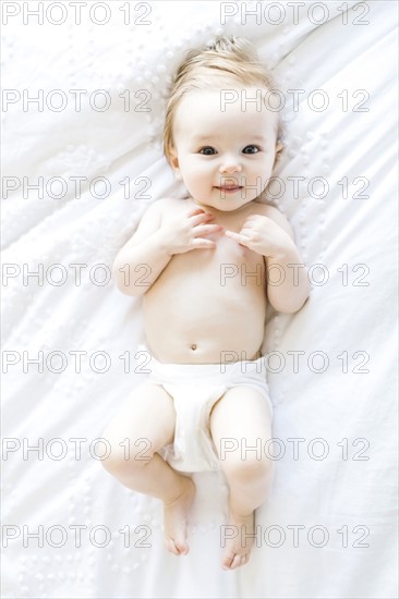 Portrait of baby girl (6-11 Months) smiling, directly above