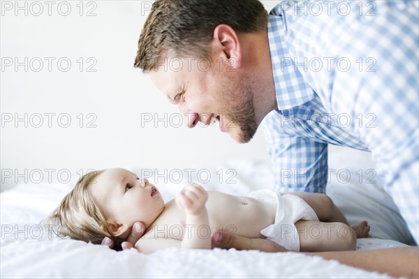 Baby girl (6-11 Months) playing with father