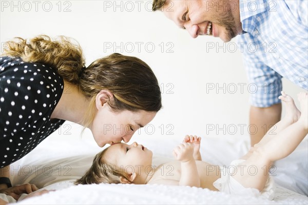 Baby girl (6-11 Months) spending time with parents