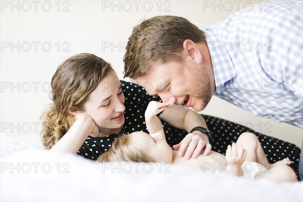 Baby girl (6-11 Months) spending time with parents