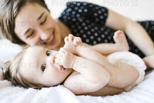 Baby girl (6-11 Months) biting foot