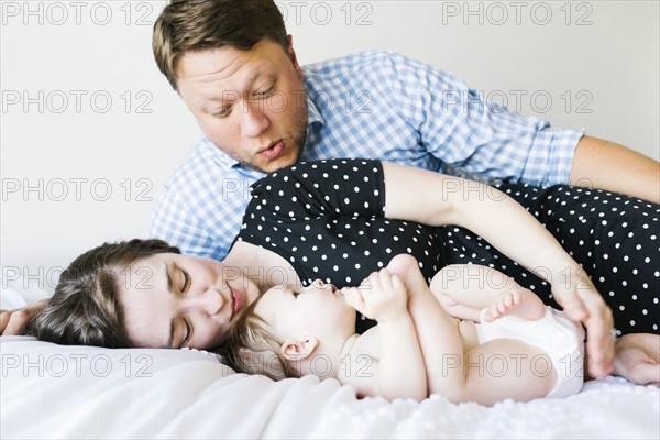 Baby girl (6-11 Months) spending time with parents