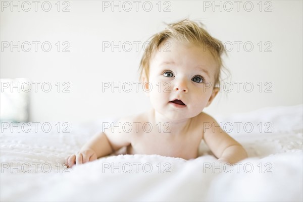 Portrait of baby girl (6-11 Months) with mouth open and tousled hair