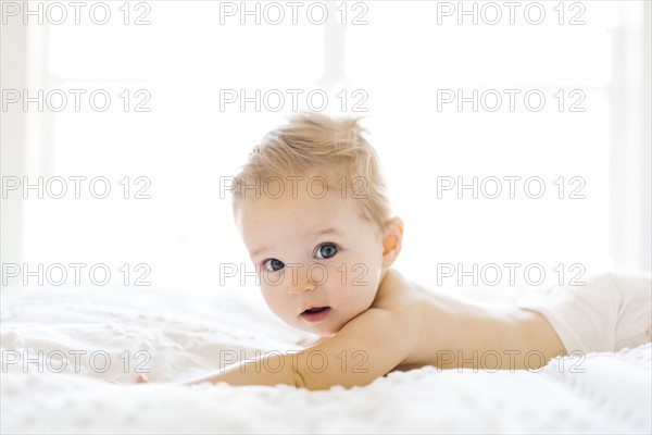 Baby girl (6-11 months) playing in bedroom