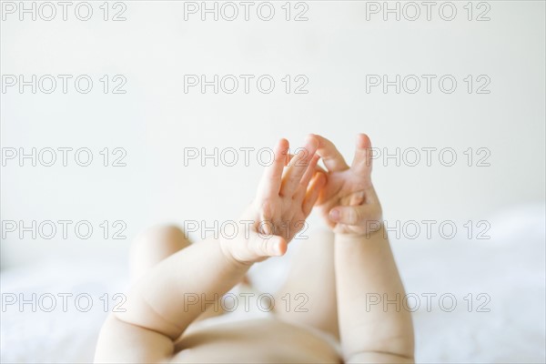 Baby girl (6-11 months) playing in bedroom