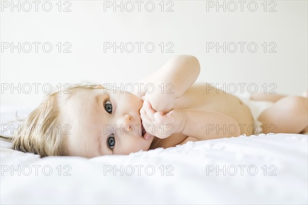 Baby girl (6-11 months) playing in bedroom