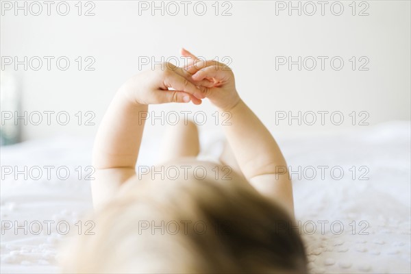Baby girl (6-11 months) playing in bedroom