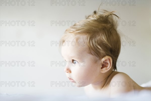 Baby girl (6-11 months) playing in bedroom