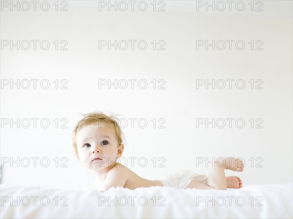 Baby girl (6-11 months) playing in bedroom