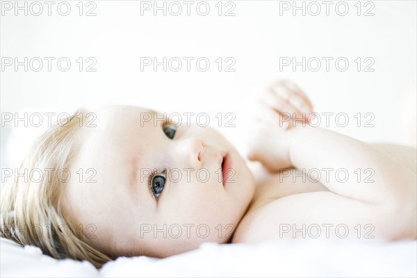 Baby girl (6-11 months) playing in bedroom