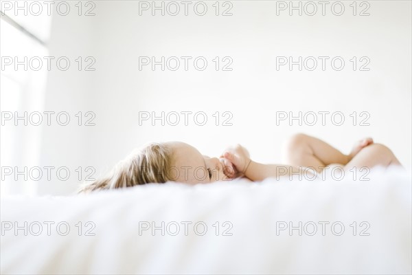 Baby girl (6-11 months) playing in bedroom